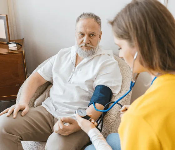 Clinician checking a patient’s blood pressure