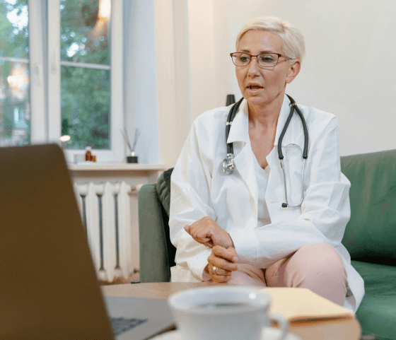 Doctor working beside a laptop